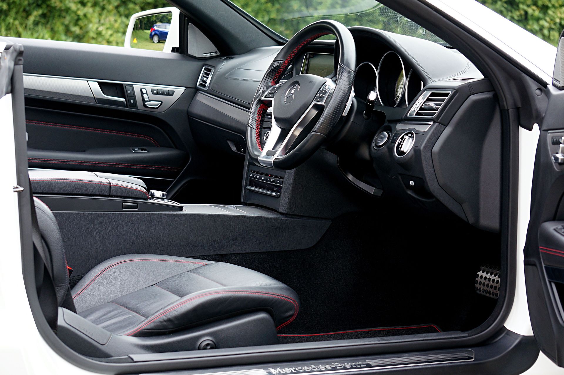 Spacious and elegant interior of a Mercedes Benz, highlighting luxury and technology.