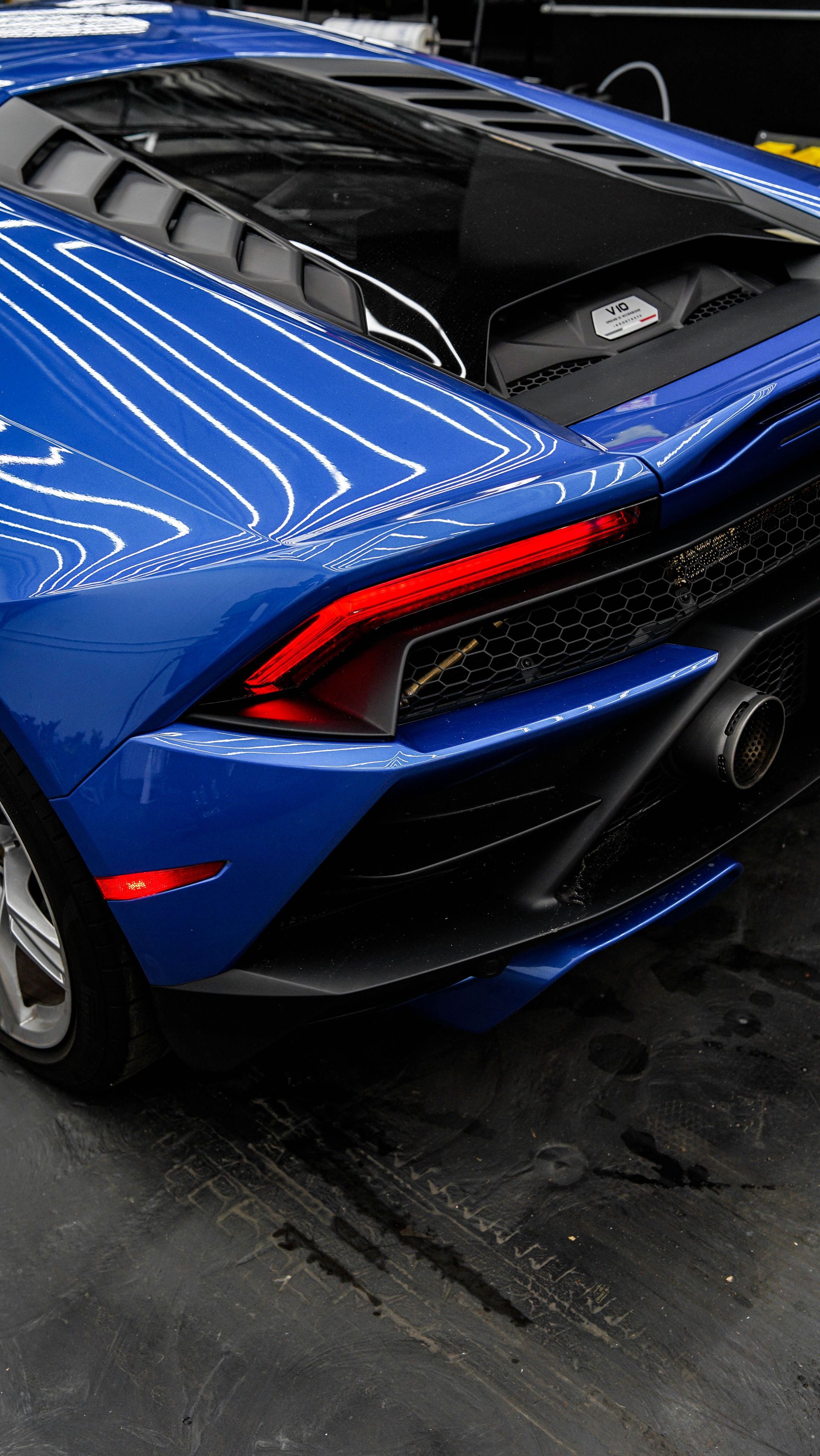 Close-up of a blue Lamborghini Huracan's rear, showcasing its sleek design and detailing.